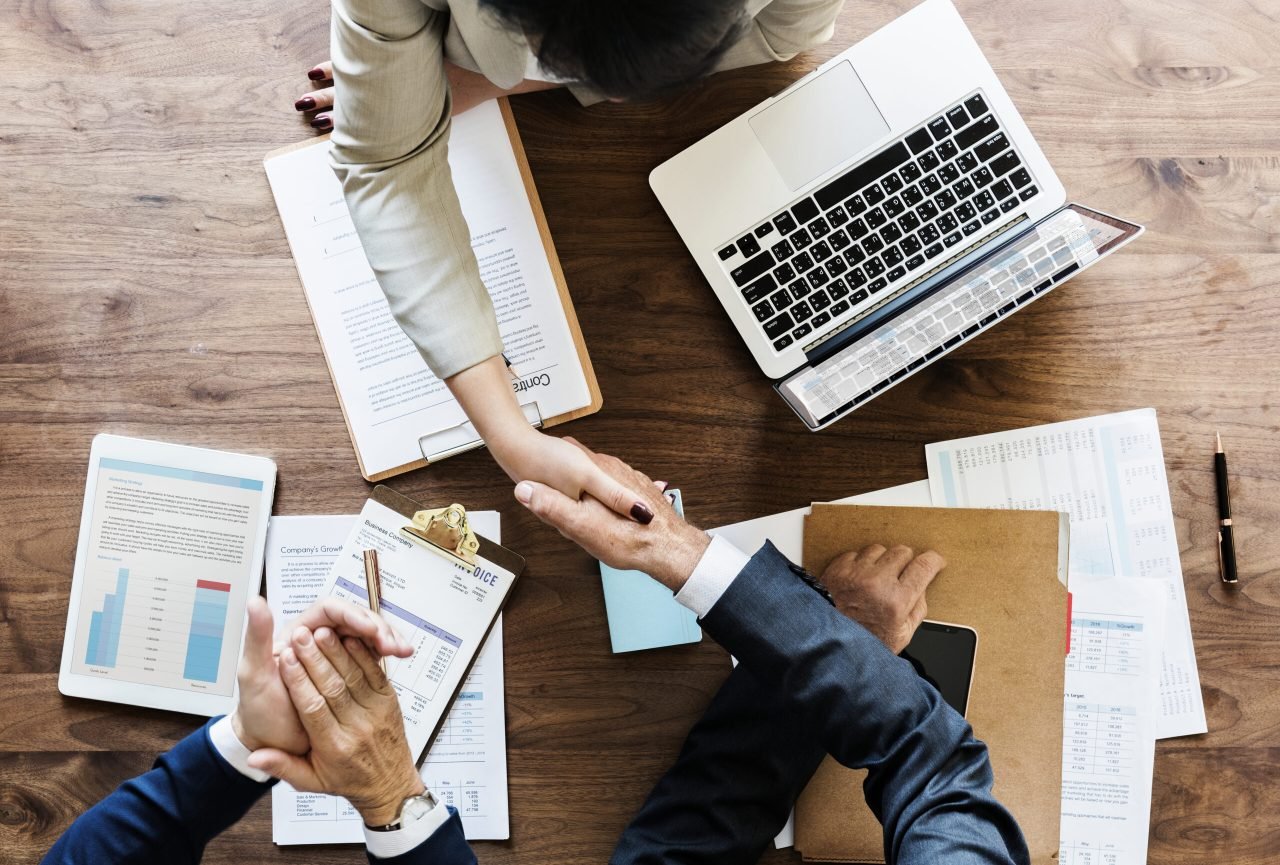 Business people shaking hands together